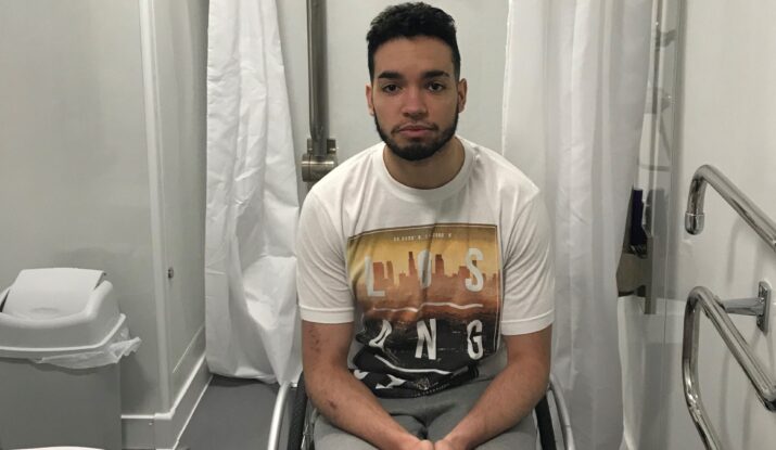 Luke in his wheelchair in his WashPod