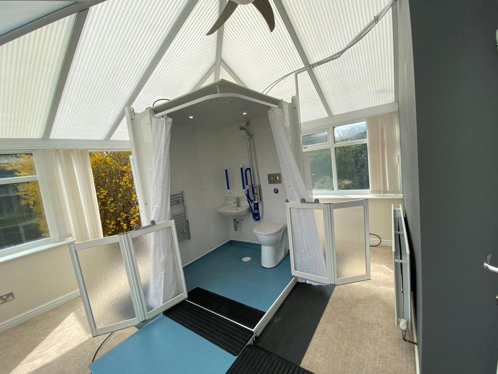 Photo showing a completed Micro WashPod inside a conservatory