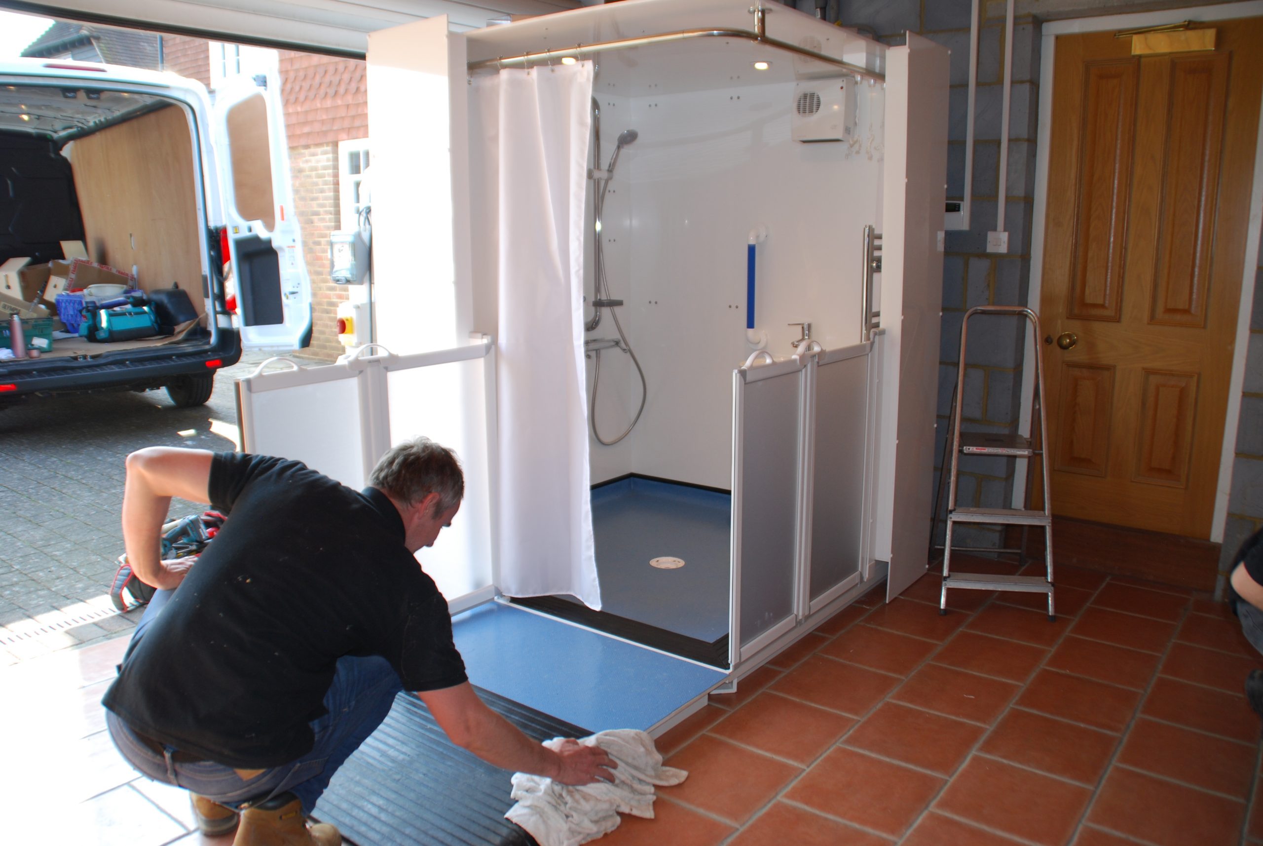 Photo of the finishing touches to a WashPod Disabled Wetroom installed in a garage