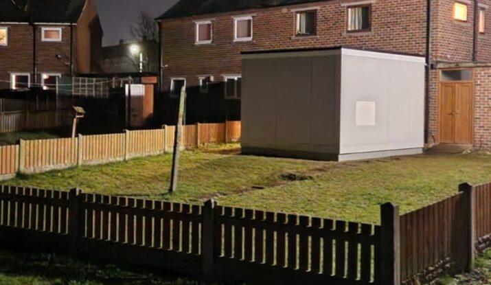 Photo showing a WashPod at night in a back garden