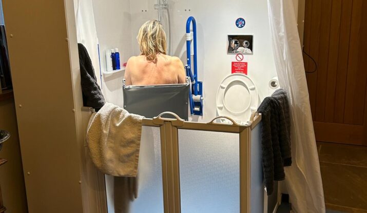Photo of Zoe in her Internal Compact WashPod temporary wetroom