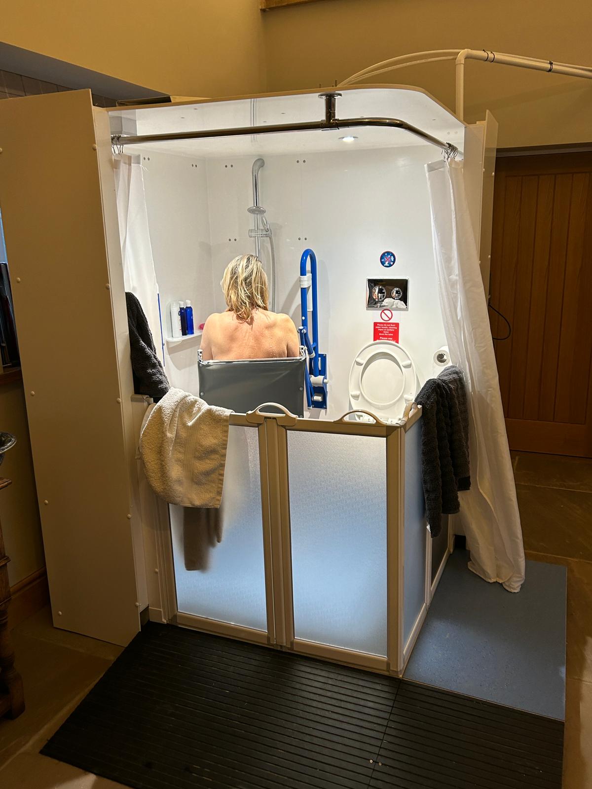 Photo of Zoe in her Internal Compact WashPod temporary wetroom