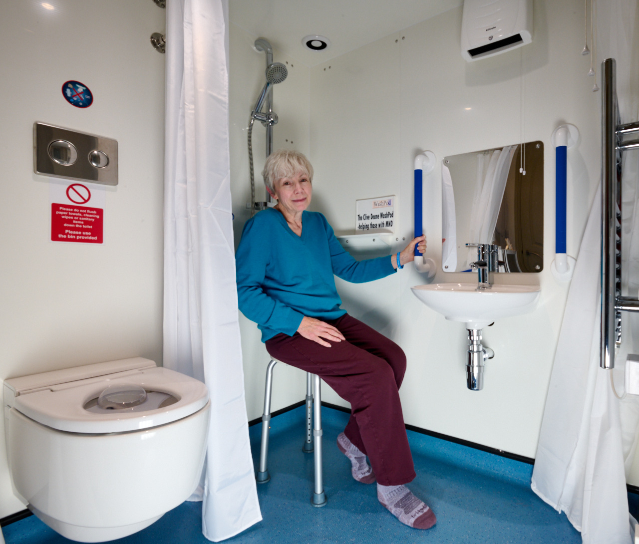 Photo shows Christine, the latest recipient of the Clive Deane WashPod for those with MND, sitting in her WashPod.
