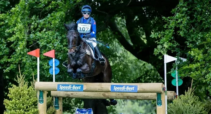 Photo of Saffron Cresswell jumping over a large evening obstacle