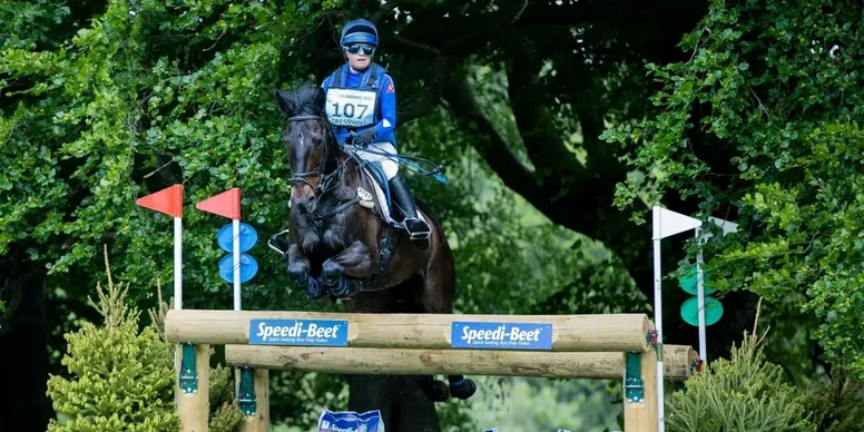 Photo of Saffron Cresswell jumping over a large evening obstacle
