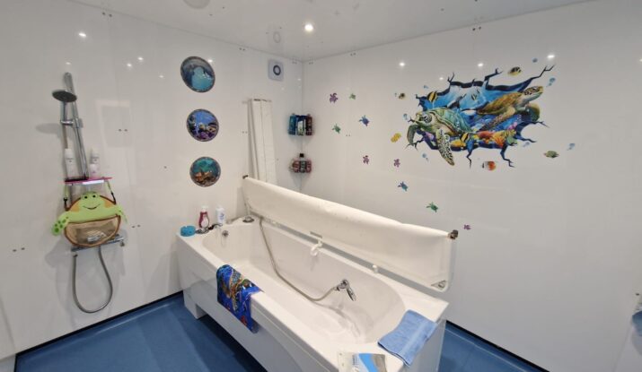 Photo showing the inside of an External Standard WashPod temporary disabled bathroom built for a teen with cerebral palsy at her grandmother's house